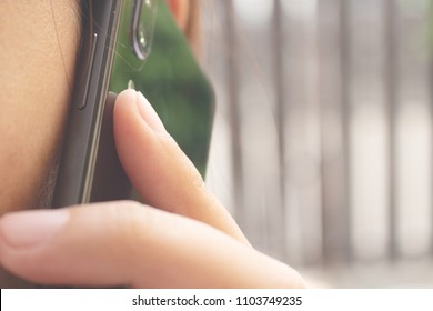 Woman Holding Smartphone Talking On The Phone In Public Place Day Light Close Up Shot