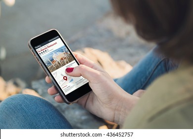 Woman Holding A Smartphone And Touching The Screen Showing Online Directory. All Screen Graphics Are Made Up.