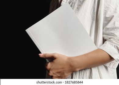Woman holding softcover book mockup. 