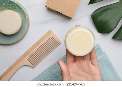 Woman Holding Solid Shampoo Bar At Marble Table, Top View. Hair Care