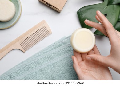 Woman Holding Solid Shampoo Bar At Marble Table, Top View. Hair Care