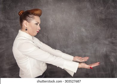 Woman Holding Something Heavy On The Blackboard Background