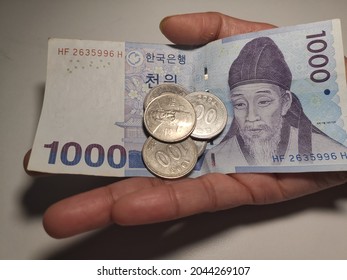 Woman Holding South Korean Currency 