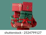 Woman holding stack of different Christmas gifts on color background