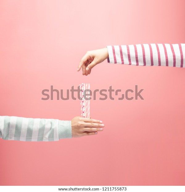 Woman holding straws for someone to draw straws,\
drawing straws on pink background, draw lots or lucky draw,\
choosing concept.