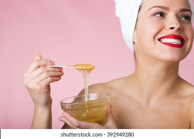 Woman holding sugar hair removing paste