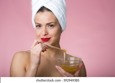 Woman holding sugar hair removing paste