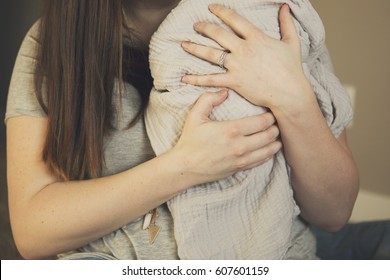 Woman Holding Swaddled Infant