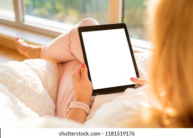 Woman holding tablet with blank empty screen