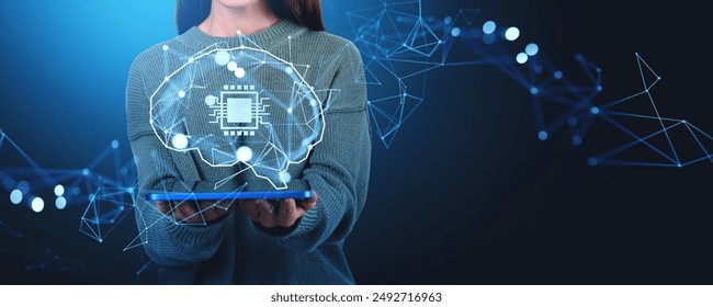 Woman holding a tablet displaying a holographic digital brain with a microchip, overlaid with network connections. Dark background. Concept of AI and technology