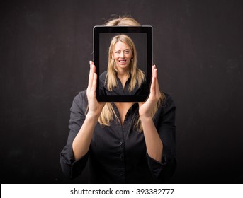 Woman holding tablet with her happy face - Powered by Shutterstock