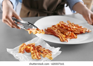 woman-holding-tasty-bacon-slice-260nw-62