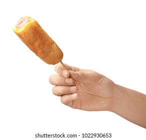 Woman Holding Tasty Corn Dog On White Background