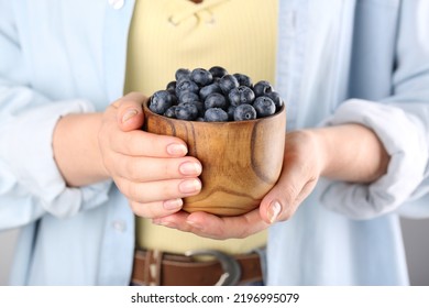 Woman Holding Tasty Fresh Blueberries, Closeup View