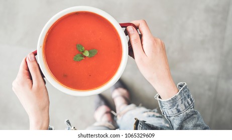 Woman Holding Tomato Soup Pot High Angle View