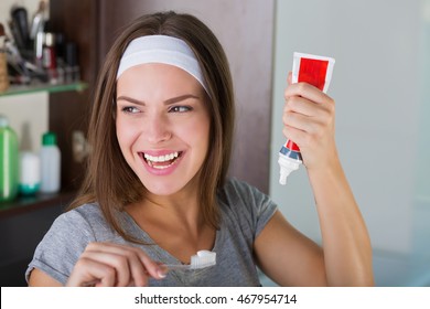 Woman Holding A Toothbrush And A Toothpaste