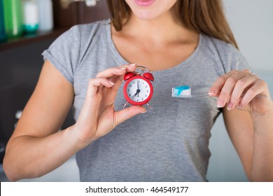 Woman Holding A Toothbrush And A Toothpaste Tube