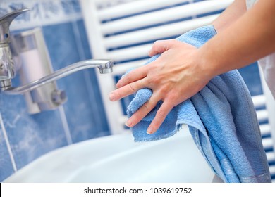 Woman Holding Towel And Drying Hands In Bathrrom