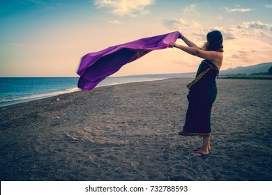 Woman Holding A Towel On The Beach In The Wind, Filtered