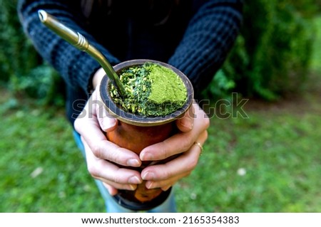 Woman holding a Traditional South American Yerba Mate tea (chimarrão in Brazil)