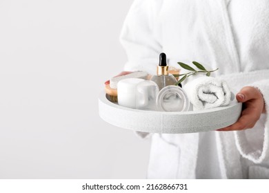 Woman Holding Tray With Bath Supplies And Vacuum Jars For Anti-cellulite Massage On Light Background