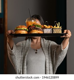 Woman Holding Tray With Fast Food Menu. Big Burgers, Fries And Fresh Orange Juice In Plastic Glass On. Nutritious Snack. Hospitable Lady Has Classic American Lunch. Tasty But Not Healthy Food.