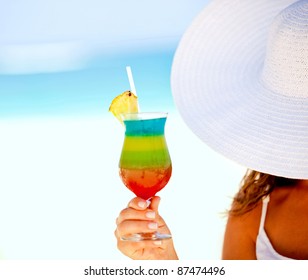 Woman Holding A Tropical Cocktail At A Beach Resort