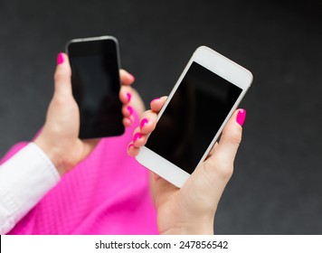 Woman holding two mobile phones