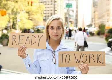 Woman Holding Up Two Signs Saying 