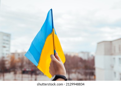 Woman holding Ukrainian yellow and blue flag during war with Russia. Invasion in Ukraine. 2022 Russian attack of Ukraine. Patriotism symbol - Powered by Shutterstock