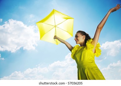 Woman Holding Umbrella Against Sun And Sky