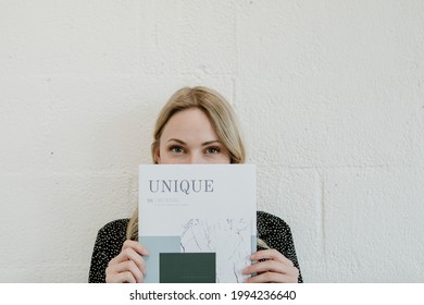 Woman Holding A Unique Magazine