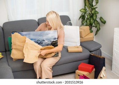 Woman Holding And Unpacking Photo Canvas Gifts