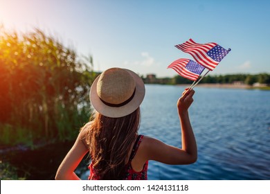 Woman holding USA flag. Celebrating Independence Day of America - Shutterstock ID 1424131118