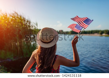 Woman holding USA flag. Celebrating Independence Day of America