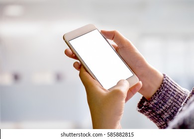 woman holding and using smartphone in corridor background. - Powered by Shutterstock