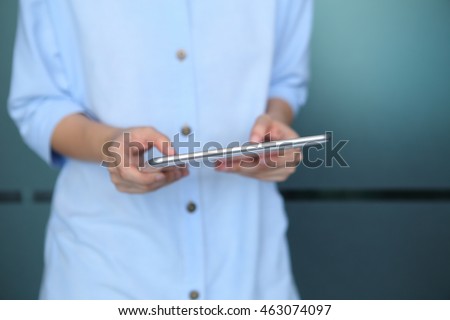 Woman holding with using tablet with office background