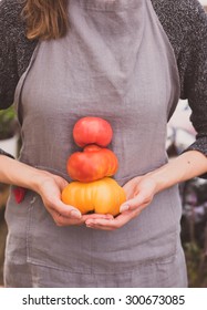 Woman Holding Variety Of Organic Heirloom Tomatoes