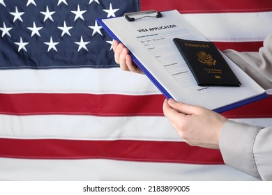 Woman holding visa application form and passport against American flag, closeup. Space for text - Shutterstock ID 2183899005