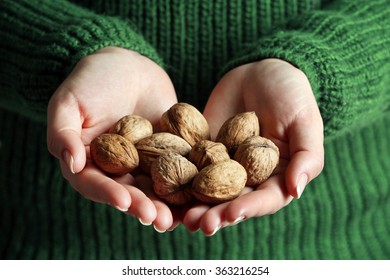 Woman Holding Walnuts, Closeup