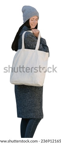 Woman holding white textile tote eco bag onwhite background