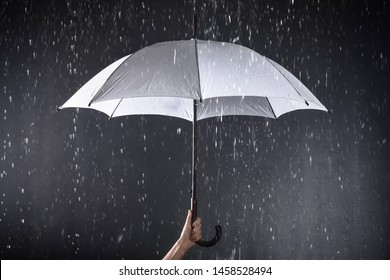 Woman Holding White Umbrella Under Rain On Dark Background, Closeup