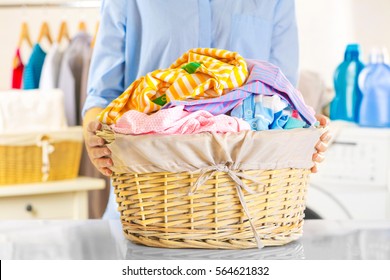 Woman Holding Wicker Basket With Clean Clothes