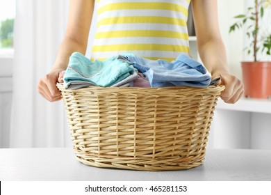 Woman Holding Wicker Basket In Laundry