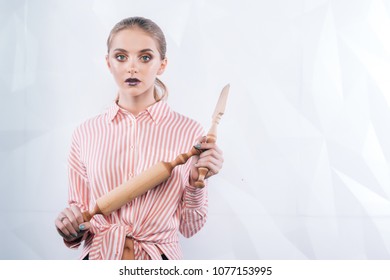 woman holding wooden rolling pin for baking sexy young woman preparing dough and rolling pin in kitchen Baker / Chef woman smiling happy holding baking rolling pin wearing uniform 