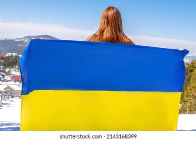 Woman Holding,fluttering,waving Ukrainian National Blue Yellow Flag.war,conflict,military Invasion Beetwen Russia And Ukraine.Ukraines Independence,Constitution Day.