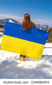 Woman Holding,fluttering,waving Ukrainian National Blue Yellow Flag.war,conflict,military Invasion Beetwen Russia As Terrorist Aggressive Country And Ukraine.Ukraines Independence,Constitution Day.