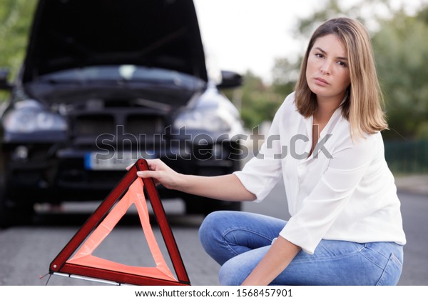 a woman holds a car\
triangle