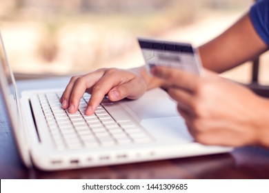 Woman holds credit card and makes online payment with laptop. Online shopping concept - Shutterstock ID 1441309685