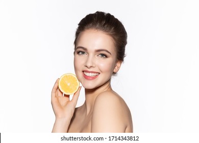 Woman Holds Cut Juicy Fruit Near Face Skin. Mask Lemon Removes Vascular Mesh, Remove Dryness And Peeling On Face. Filling Dry Epidermis With Moisture. Girl Softens Skin Eliminates Peeling.